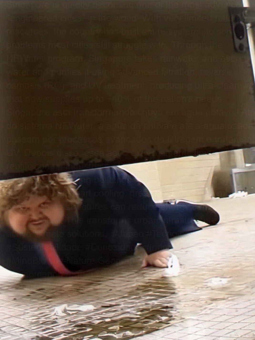 A man squeezing underneath a low barrier.